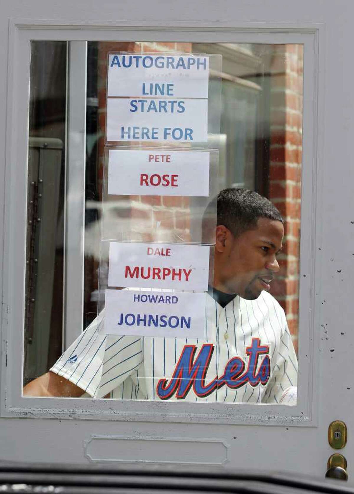 Lamont Aulet of Brooklyn, N.Y., leaves a shop after getting an autograph in Cooperstown, N.Y., on Saturday, July 23, 2011. The National Baseball Hall of Fame holds its induction ceremony on Sunday. (AP Photo/Mike Groll)