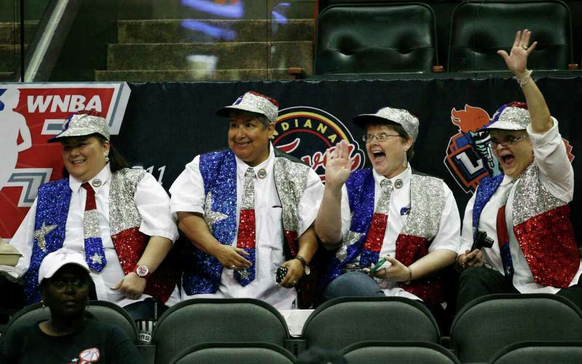 Fans Peggy Arp (from left), Espe Garcia, Suzanne Kenoyer and Jackie Freeman cheer and wave before the WNBA All-Star game on Saturday, July 23, 2011, at the AT&T Center.