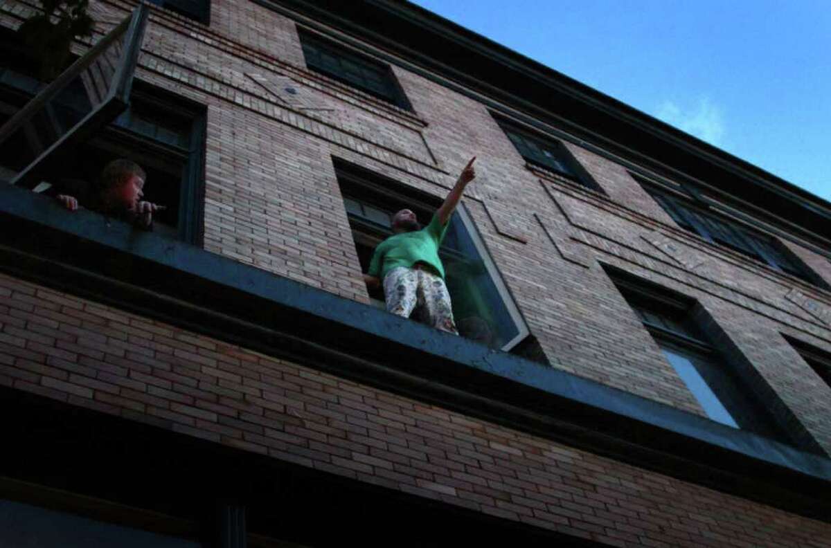 Les Savy Fav lead singer Tim Harrington performs in an apartment window, high over the crowd on day two of the Capitol Hill Block Party.