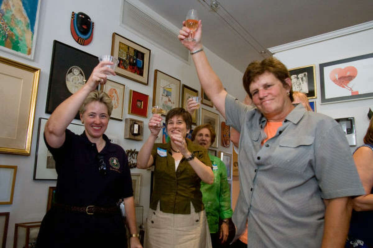 Houston City Controller Annise Parker, left, Jane Cahill of the Old Sixth Ward Neighborhood Association; Virginia Roeder and Houston City Council member Sue Lovell toast the success of the preservation effort at a reception celebrating the designation of the Old Sixth Ward Historic District.