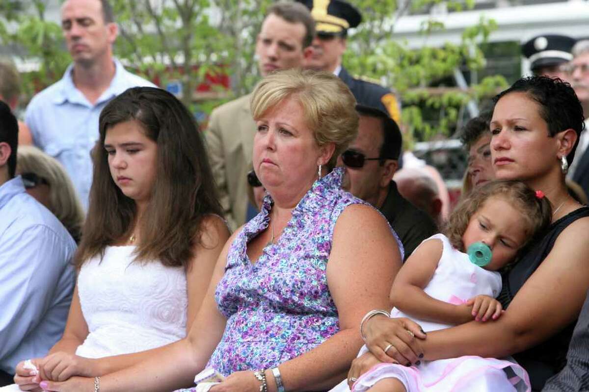 Family members, from left, Margaret Baik, Laurie Baik, Marianne Velasquez, and Salina Velasquez, attend a Bridgeport Fire Department Memorial Dedication ceremony honoring firefighter Michel Baik and Lt. Steven Velasquez on Sunday, July 24, 2011. The firefighters were killed in the line of duty last year. The ceremony took place at the Engine 7/ Ladder 11 firehouse on Ocean Terrace.