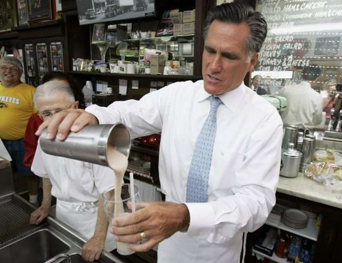 Mitt Romney pours a milkshake during a campaign stop Wednesday at the Wilton Candy Kitchen in Wilton, Iowa.