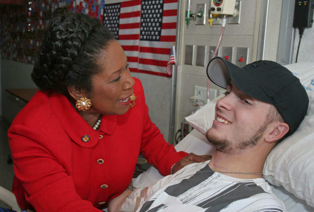 U.S. Rep. Sheila Jackson Lee, D-Houston, visits Dillon Cannon on Sunday at the Michael E. DeBakey Veterans Affairs Medical Center. Cannon, who spent three weeks at Walter Reed after being injured in Iraq, said his focus is not on the Walter Reed scandal, it's on getting better.