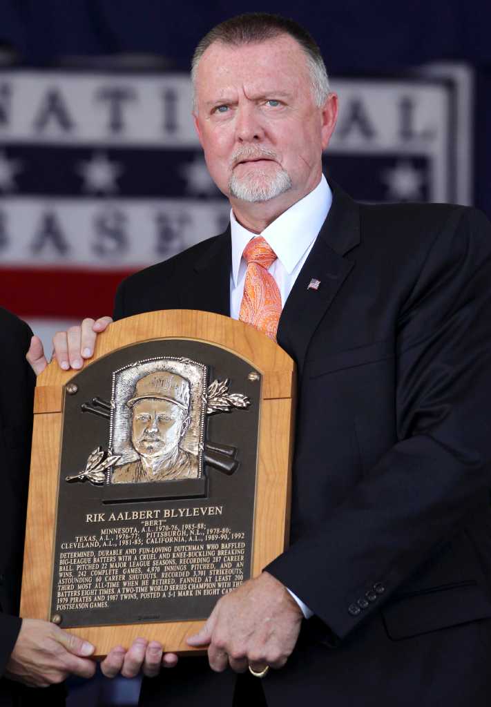 Roberto Alomar holds his plaque after his induction into the Baseball Hall  of Fame in Cooperstown, N.Y., on Sunday, July 24, 2011. (AP Photo/Mike  Groll)