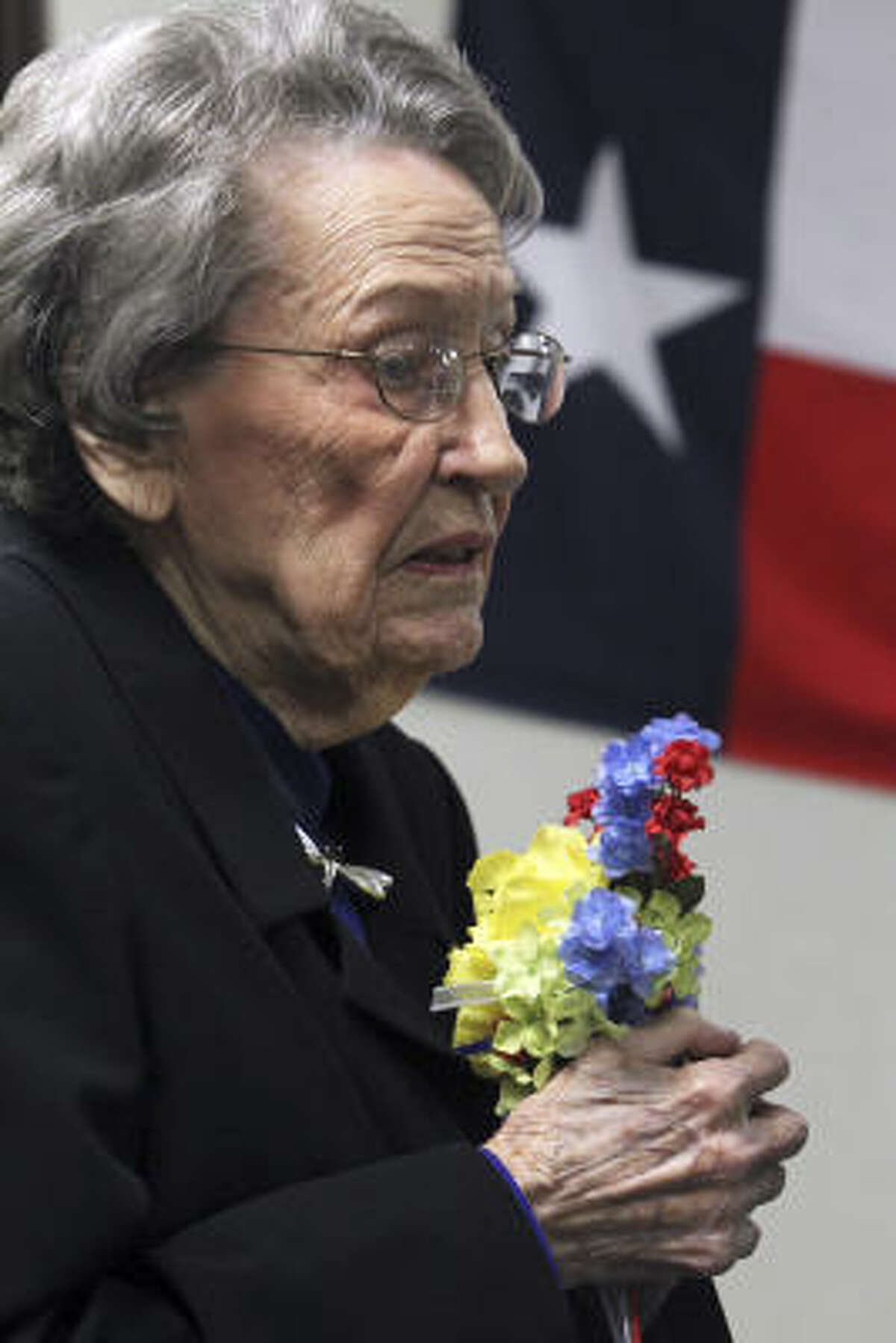 Ella Wheeler-McLeod, sister of highway patrolman Edward Bryan Wheeler, accepts the Yellow Rose of Texas award.