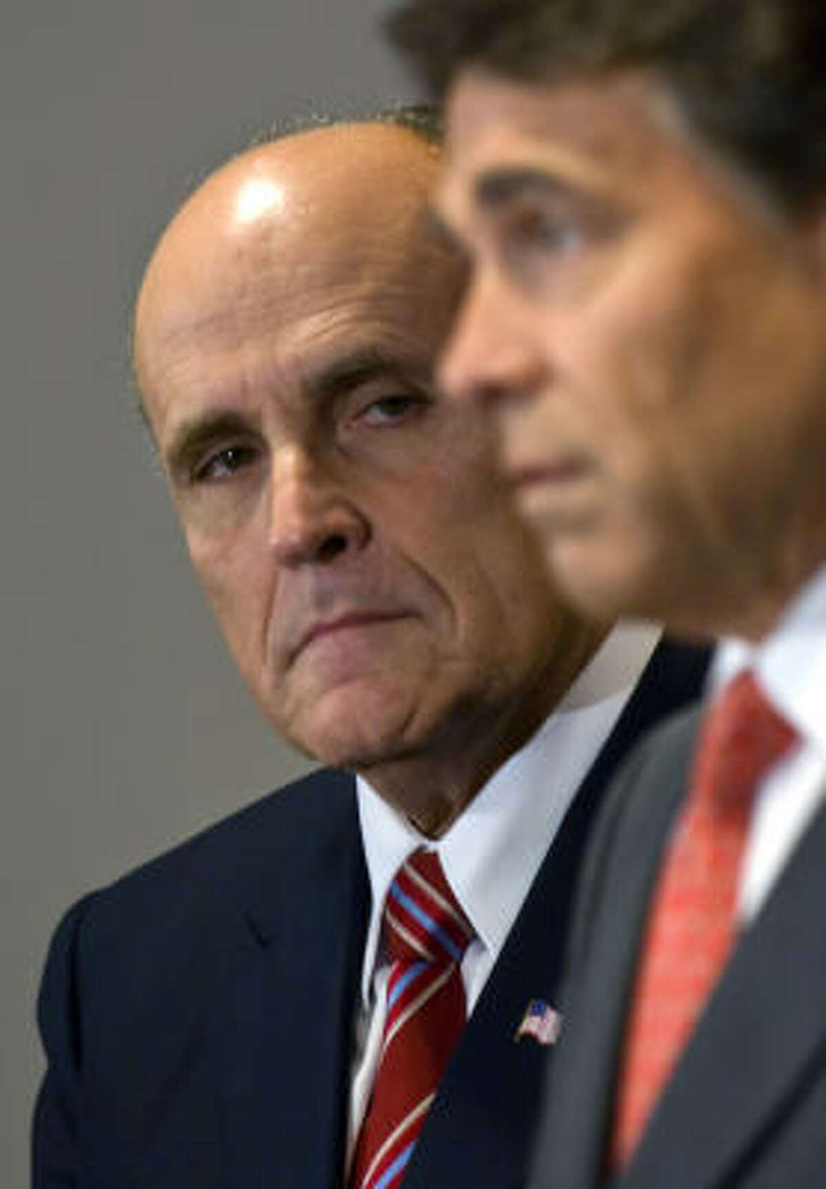 Gov. Rick Perry says Rudy Giuliani "knows how to win.''
