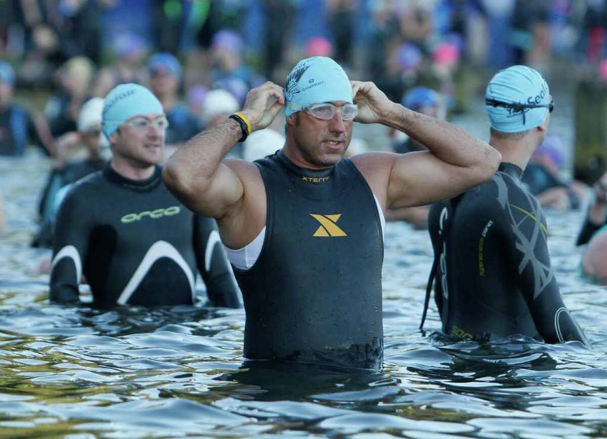A man Prepares his goggles before starting the Benaroya Research Institute Seafair Triathlon at Seward Park in Seattle on Sunday, July 24, 2011