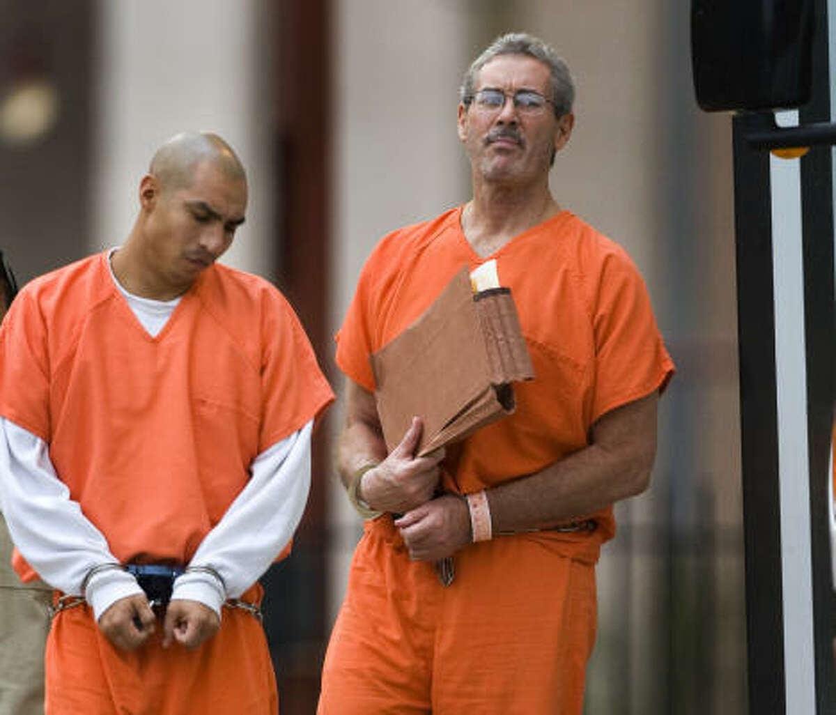 R. Allen Stanford, right, arrives at the federal courthouse on Tuesday for his fraud case.