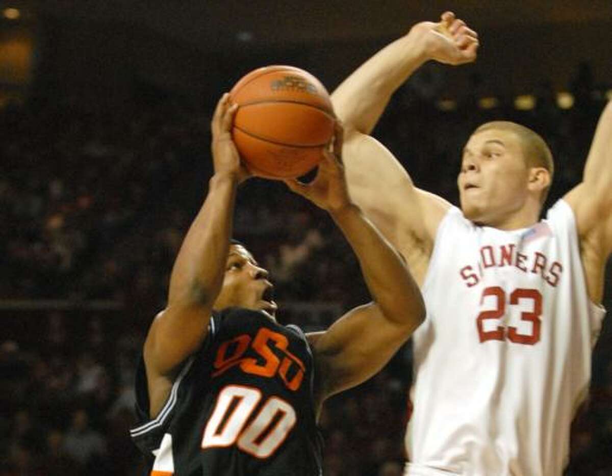 Oklahoma State's Byron Eaton, left, challenges Oklahoma forward Blake Griffin during the Sooners' 64-61 victory Monday night.
