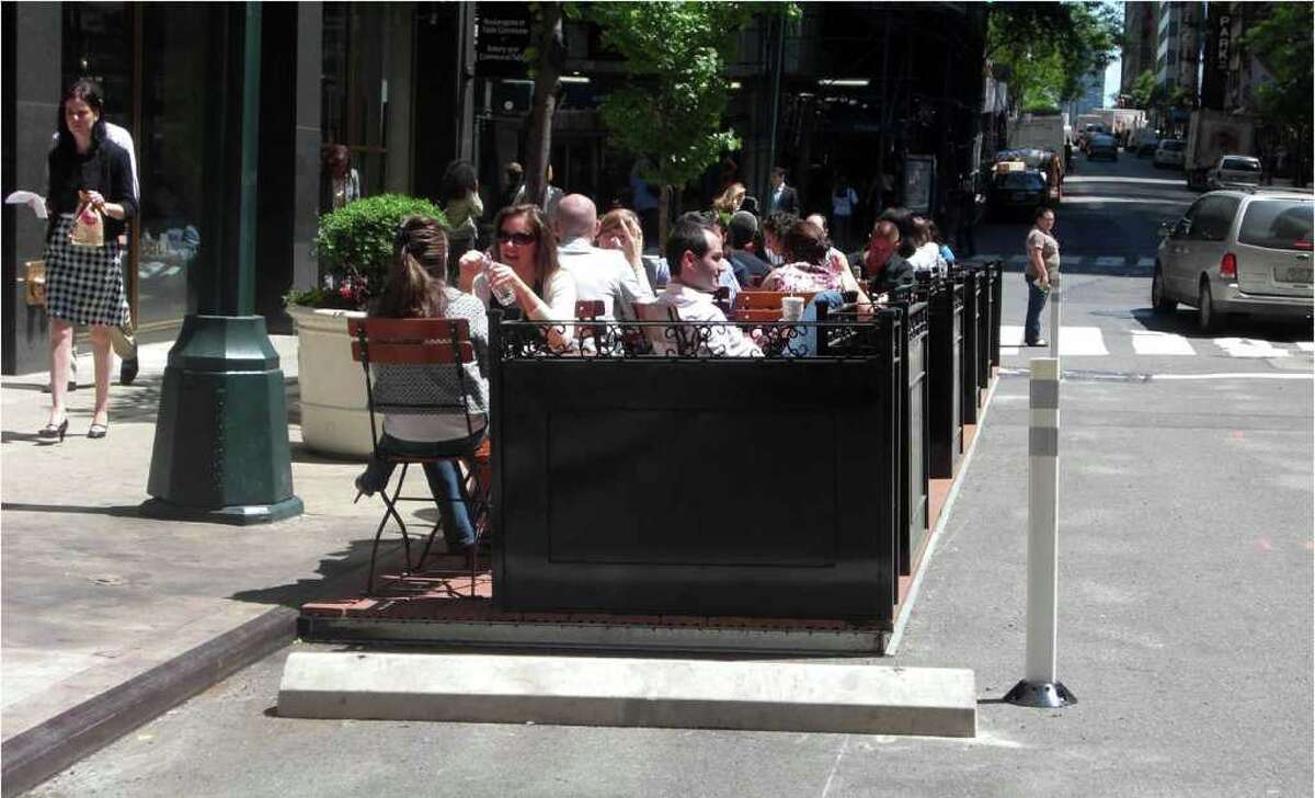 Pop-out seating, seen here at 44th Street and Third Avenue in Manhattan, converts parking spaces into outdoor dining areas.