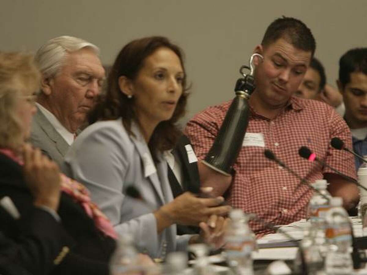 Ursula Henderson, head of the regional office of the U.S. Department of Veterans Affairs, was among the federal officials at the George R. Brown Convention Center on Monday who acknowledged shortcomings in the system that affect veterans such as Marine Sgt. James "Eddie" Wright, of Willis, right.