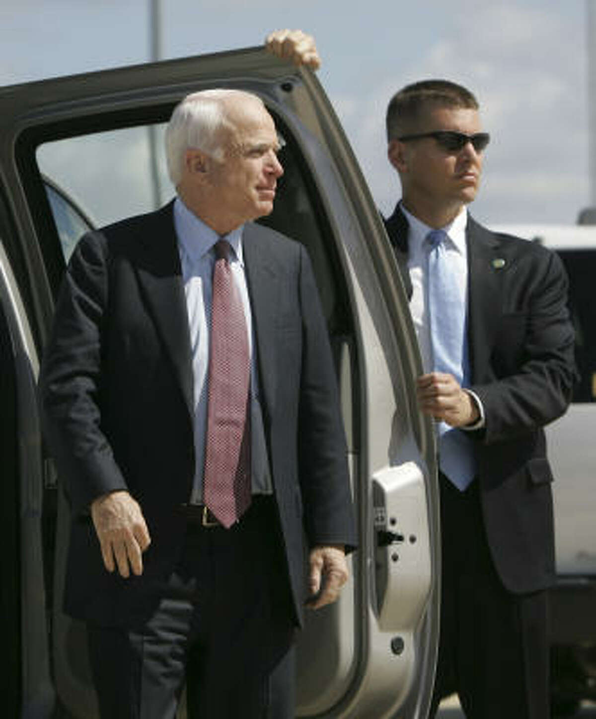 A Secret Service agent holds open a door for Republican presidential candidate Sen. John McCain in Orlando, Fla., last week.