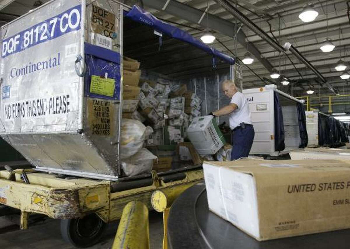 Cargo agent Mark Zalar unloads mail at Continental's facility at Bush Intercontinental Airport.