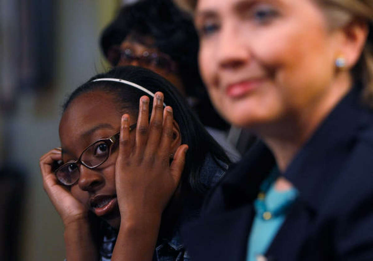 Da'Nelle Grier sneaks a peek at Hillary Clinton at a campaign event in Inglewood, Calif., on Saturday.