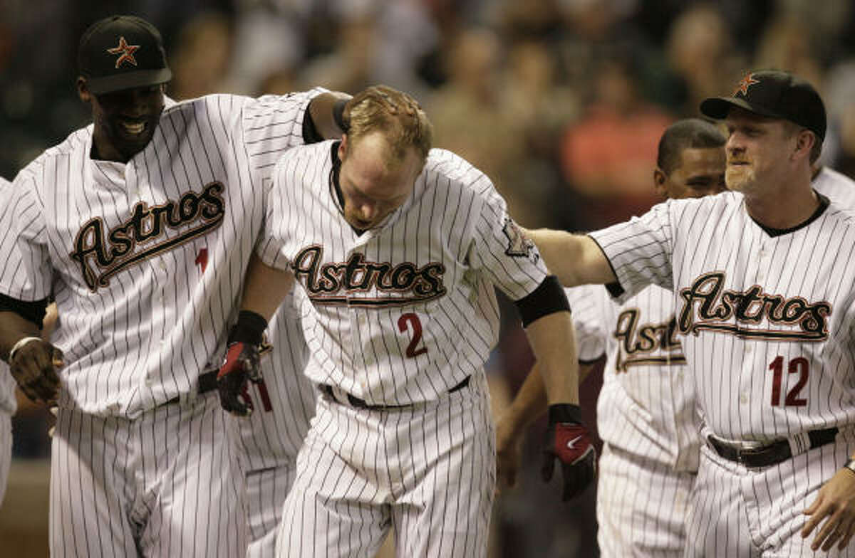 Darin Erstad, center, gets mobbed by teammates after his walk-off homer gave the Astros a 5-4 win over the Atlanta Braves.