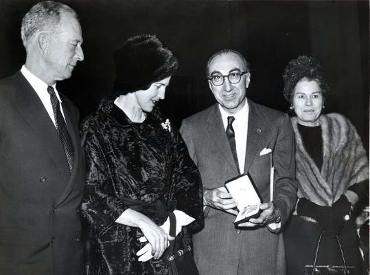 Michael DeBakey, with his first wife, Diana, at right, displays the the Grand Cross Order of Leopold he received from abdicated King Leopold, left, and Princess Lilian of Belgium in 1962.