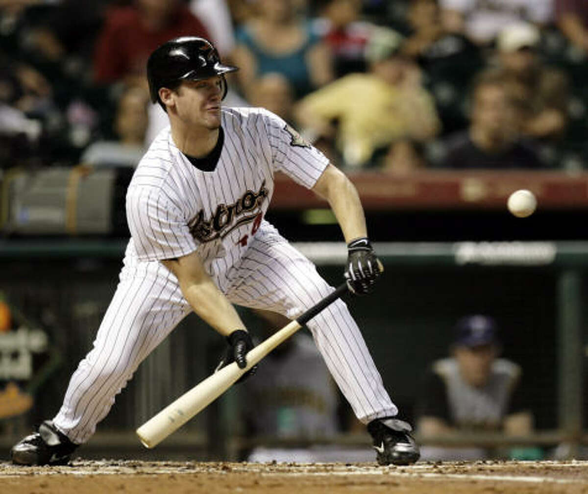 Roy Oswalt lays down a sacrifice bunt to bring home Reggie Abercrombie against the Pittsburgh Pirates in the third inning on Thursday at Minute Maid Park.