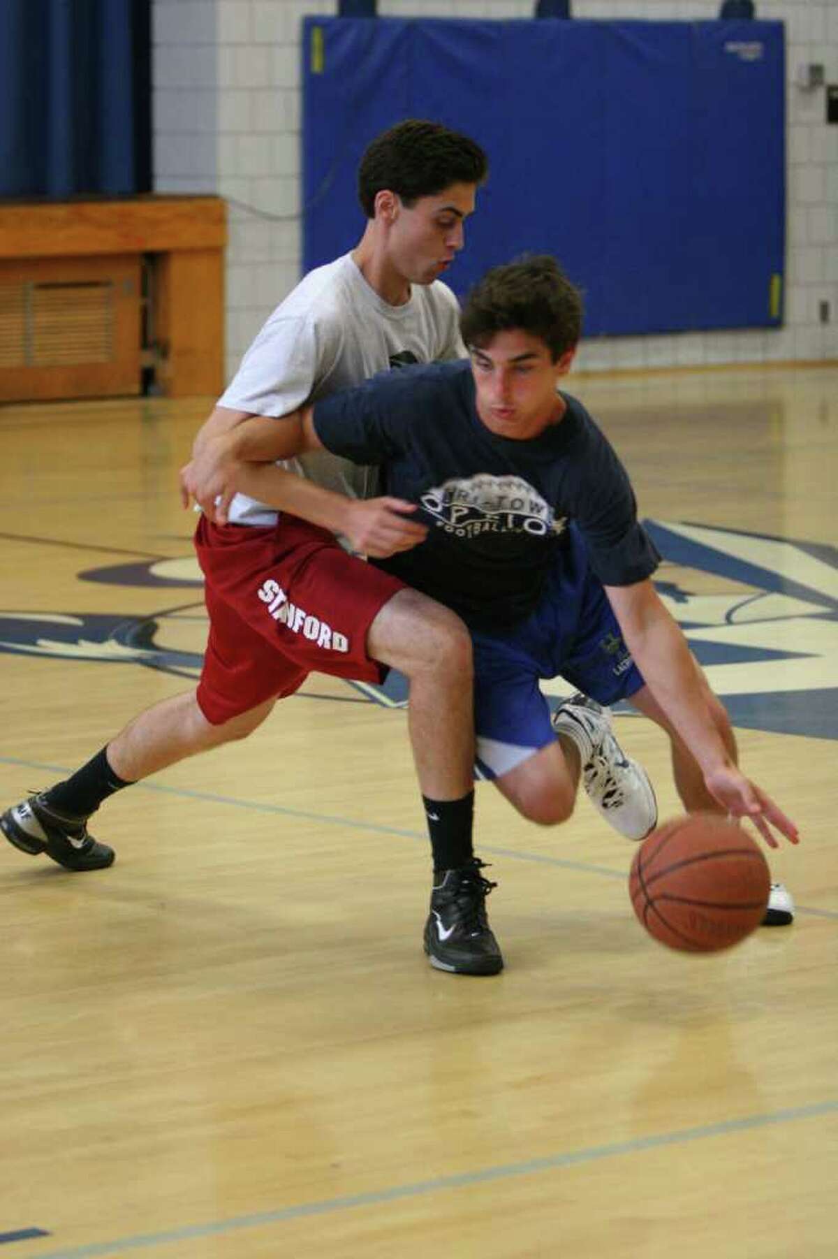 Incoming Staples junior James Frusciante, right, tries to drive past a Hopkins player Sunday in a DeSantis Basketball Academy Summer Basketball League game at Christian Heritage School. Frusciante is developing his game and chemistry with his teammates this summer.