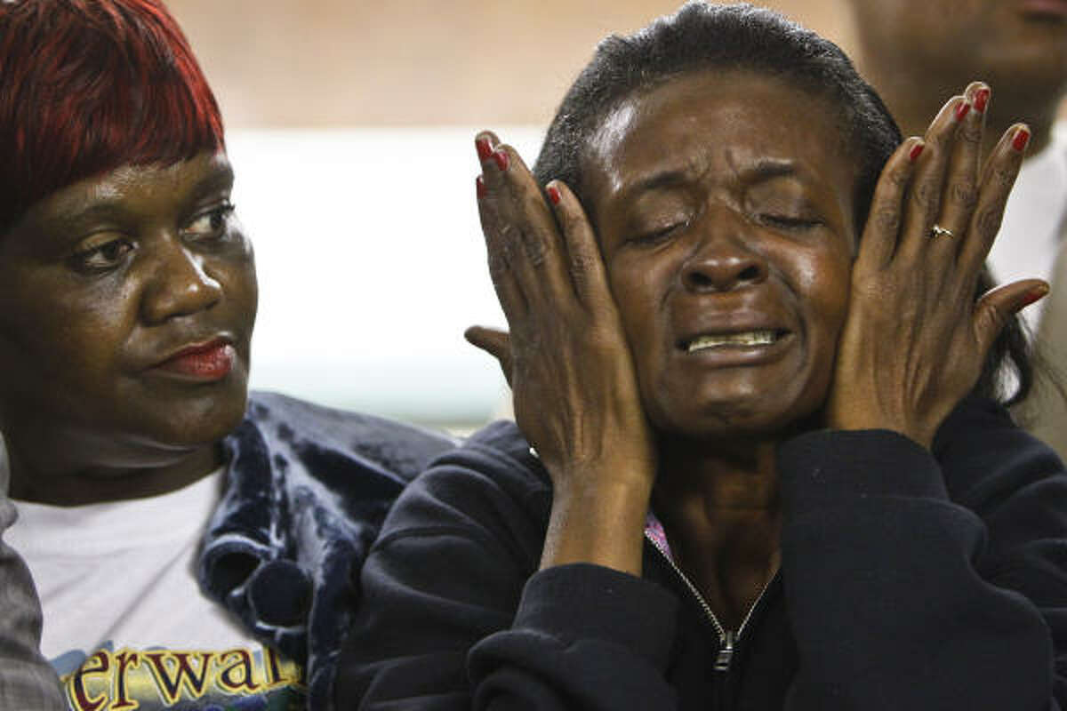 Anita Ellis wipes away tears as she and Daphne Straughter listen to Houston community activist Quanell X, who held a rally in Cleveland where he requested funds for lawyers for suspects in the gang rape of an 11-year-old girl. Ellis said her son, Timothy Ellis, was one of the first men to turn himself in to police.