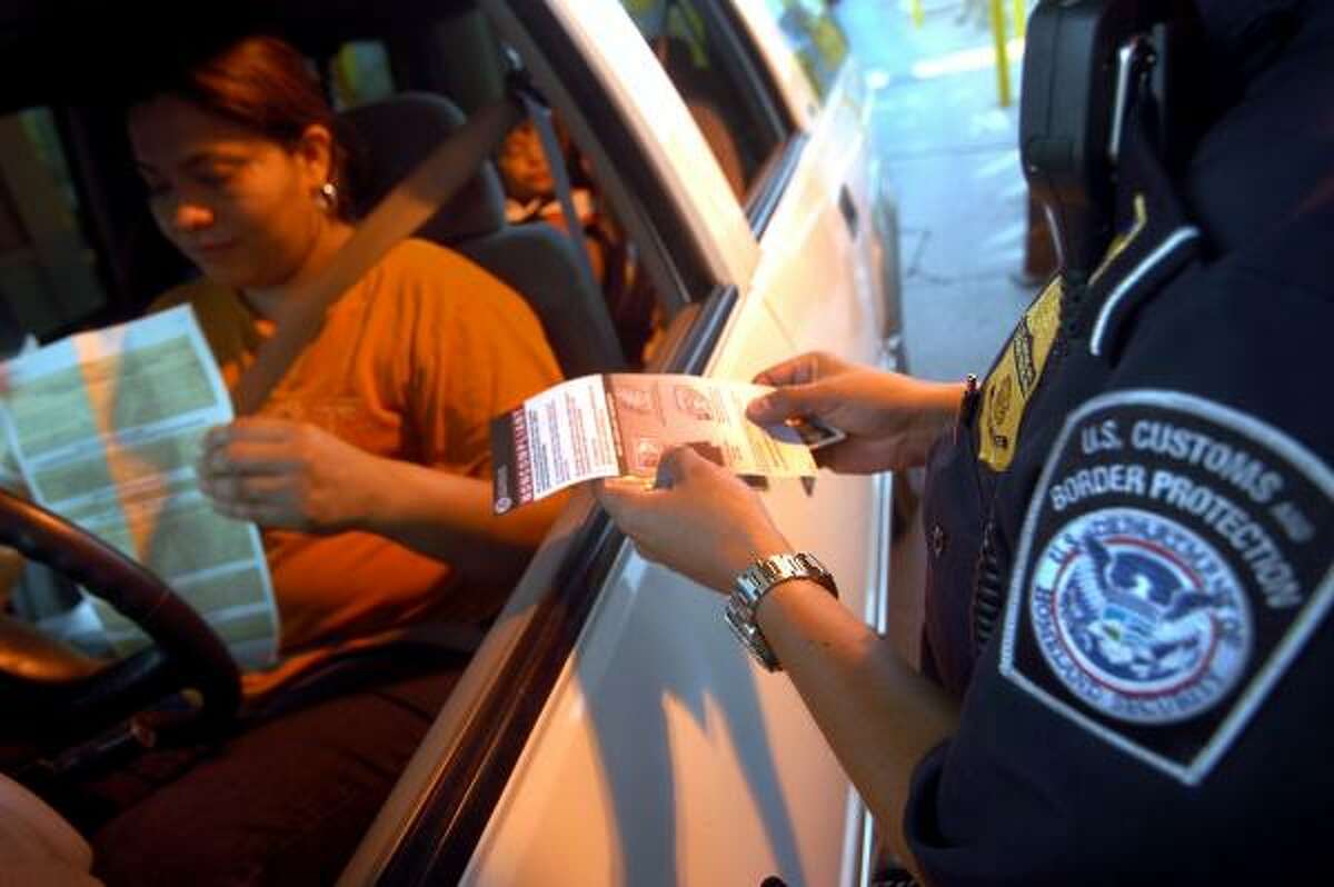 A driver's documents are checked Monday at the border in Brownsville.