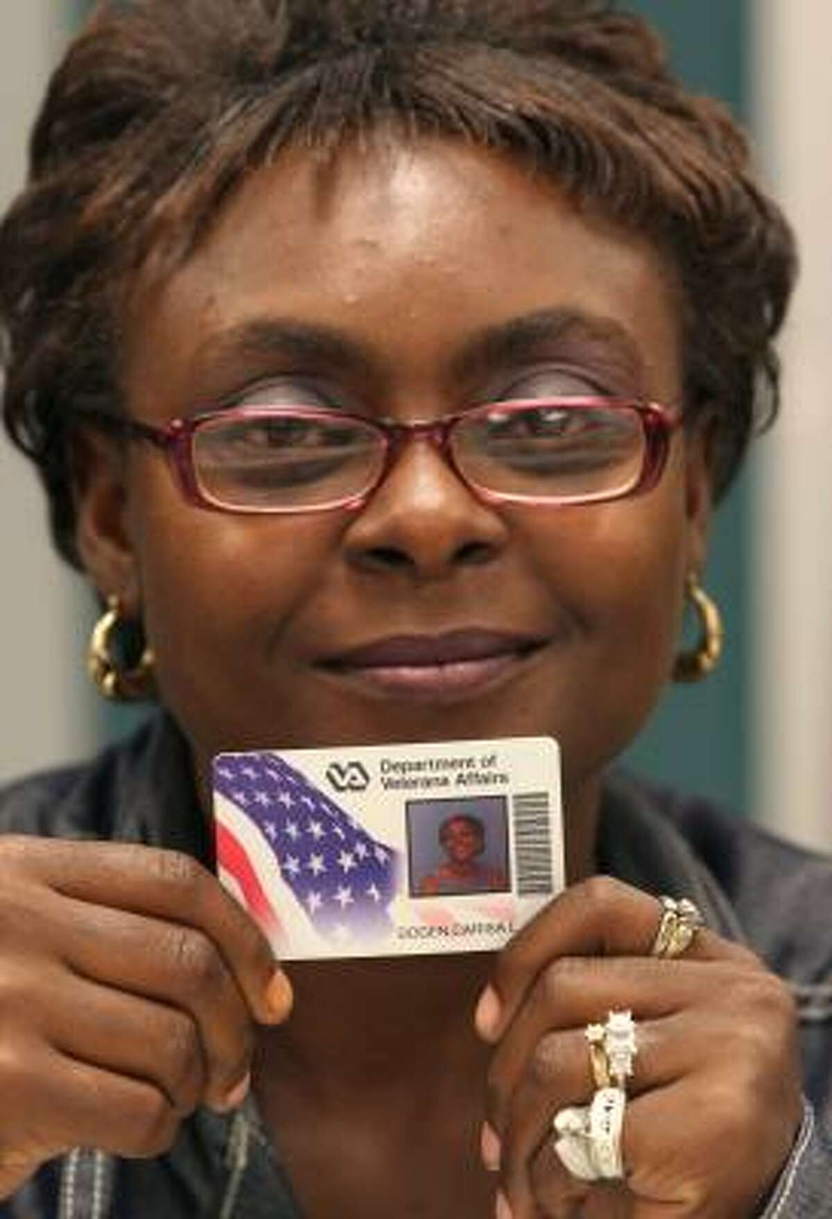 Carisa Dogen shows her Veterans Affairs ID card in Dayton, Ohio.