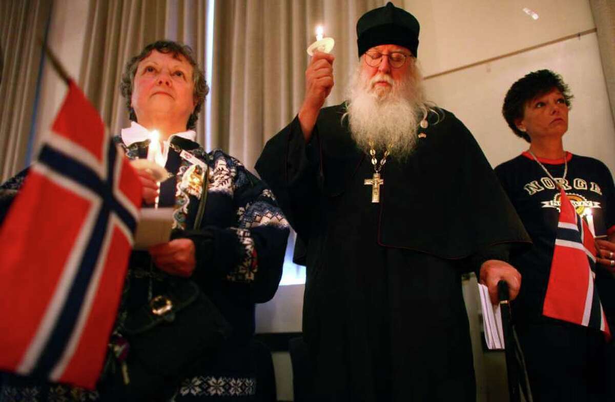 From left, Vicki Nelson of th Sons of Norway in Edmonds, Russian Orthodox Abbott Tryphon, and Sons of Norway member Kirsten Holm participate in a vigil of remembrance at Seattle's Nordic Heritage Museum on Tuesday, July 26, 2011. Seattle's large Nordic population has been shaken by the violent attacks in Norway that killed 76 people, mostly children.