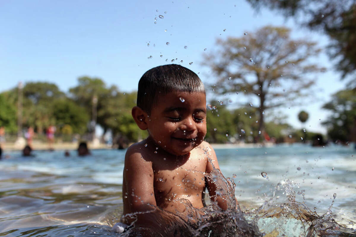 Victor Reyes, 1, splashes in the San Pedro Springs Park pool in San Antonio on July 26, 2011.
