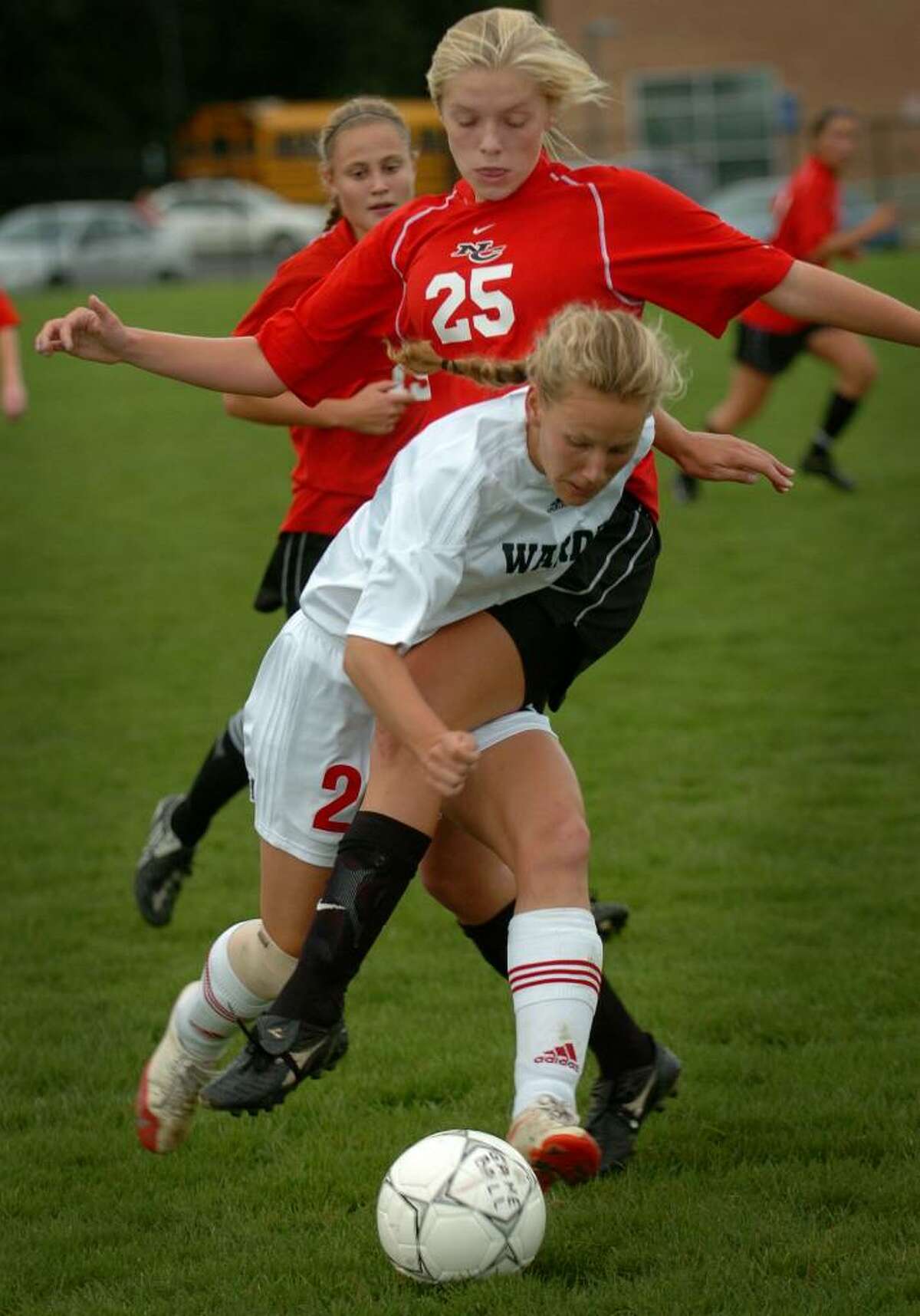 Fairfield Warde's Sarah Duffy locks up with New Canaan defender Kelly Armstrong during their FCIAC matchup at Warde High School in Fairfield, Conn. on Wednesday, September 30, 2009.