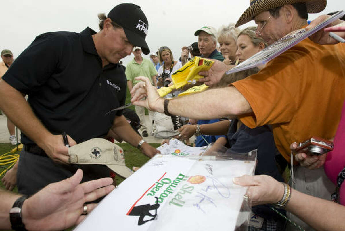 Phil Mickelson signs autographs after his round in the Shell Houston Open Grand Pro-Am on Wednesday.