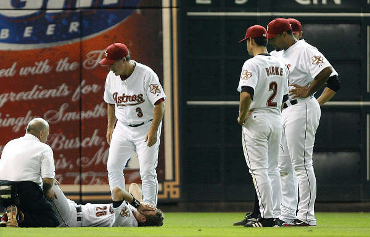 Astros head trainer Dave Labossiere and manager Phil Garner tend to Adam Everett's injured leg as Chris Burke, Carlos Lee, and Hunter Pence watch.