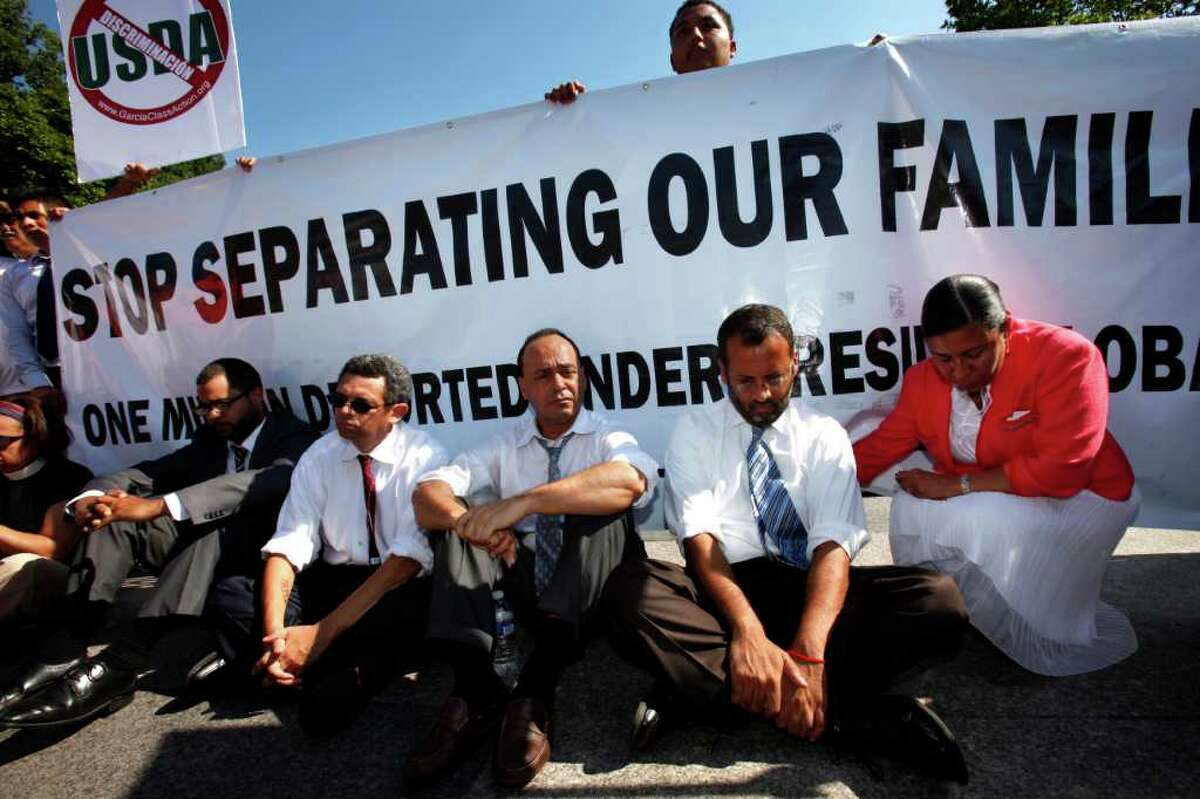 Supporters of the DREAM Act, including Rep. Luis Gutierrez, D-Ill., third from right, wait to be arrested while performing an act of civil disobedience at a rally for supporting the DREAM Act and immigration reform outside the White House in Washington, on Tuesday, July 26, 2011.