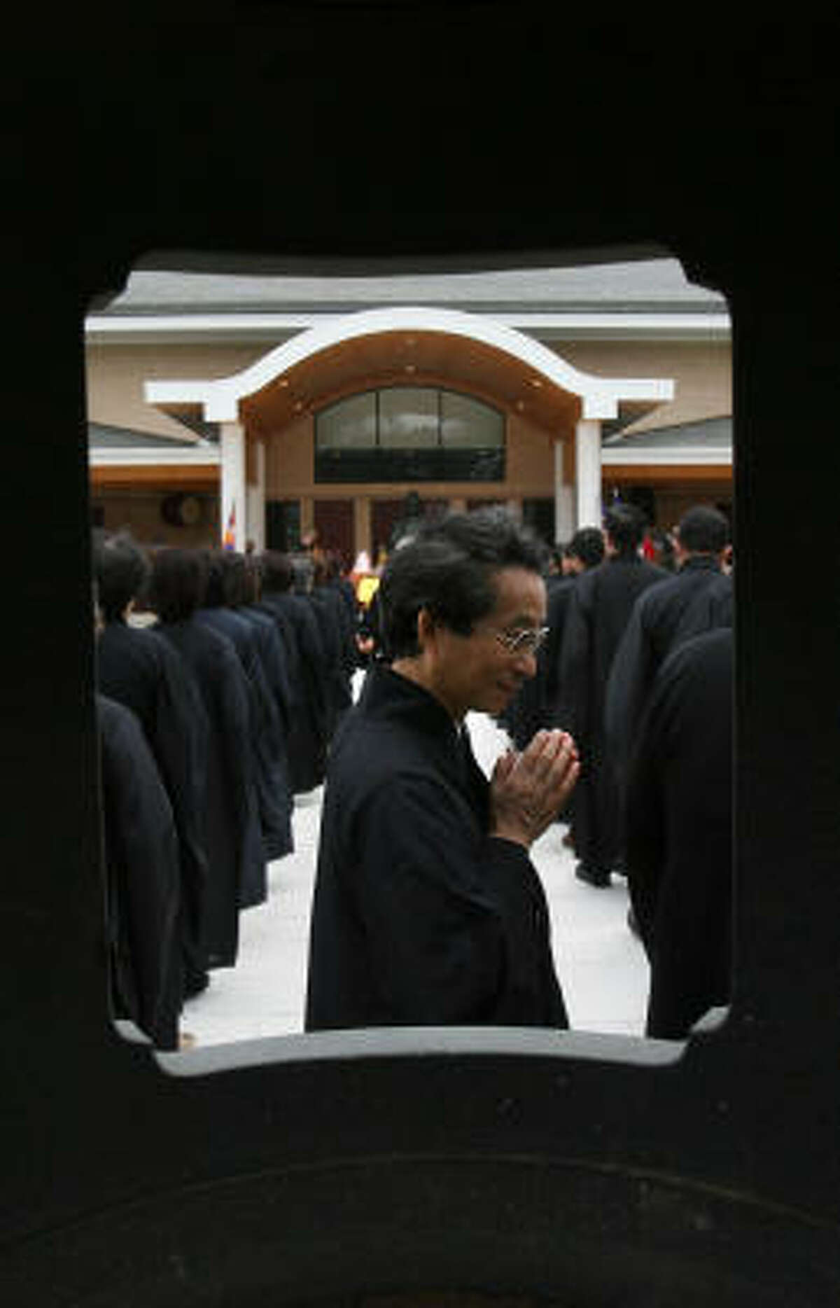 John Hsu joins members and volunteers during the American Bodhi Center opening ceremony Saturday in Hempstead.