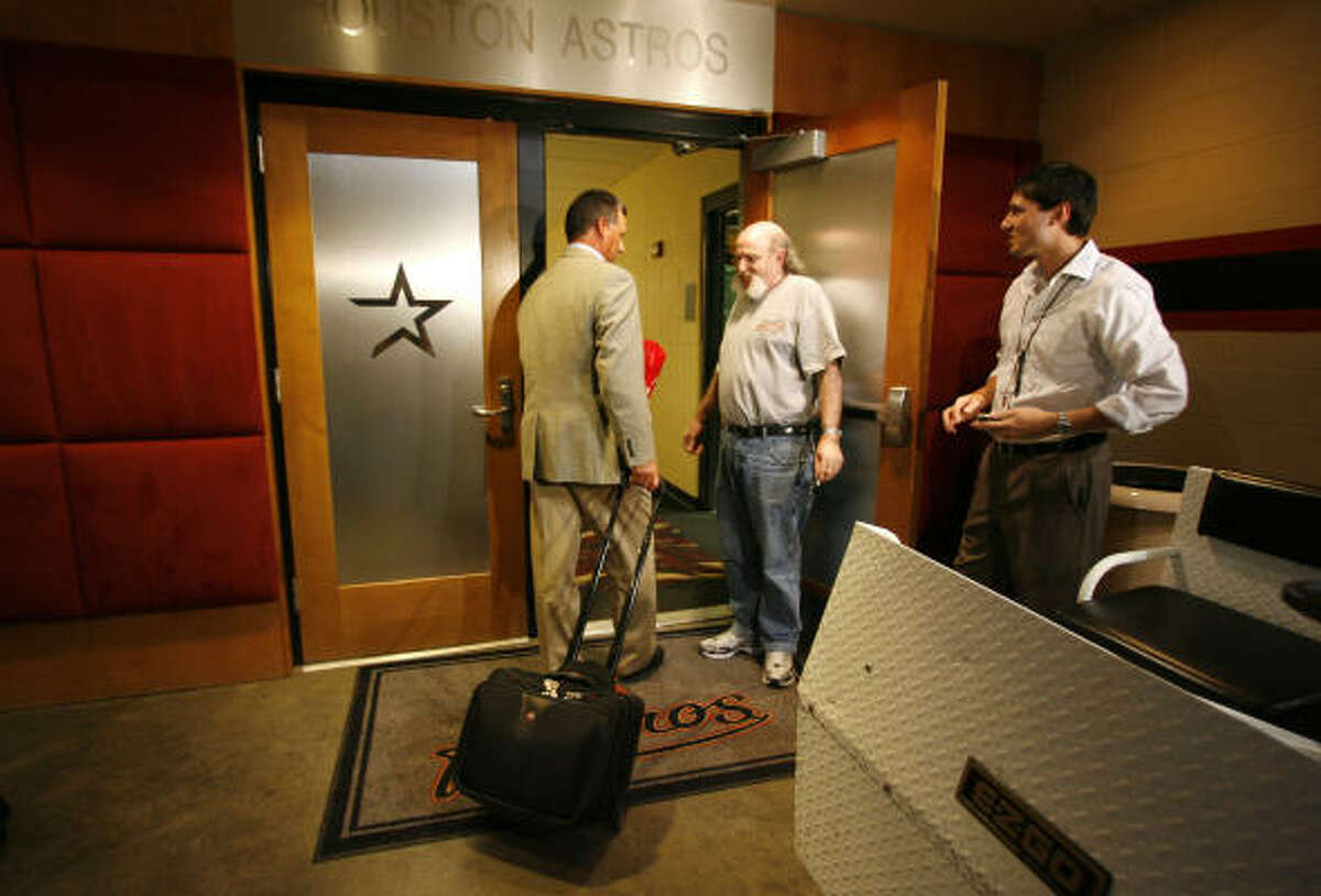 Al Pedrique, left, walks into the Astros clubhouse after finishing his interview and subsequent press conference.