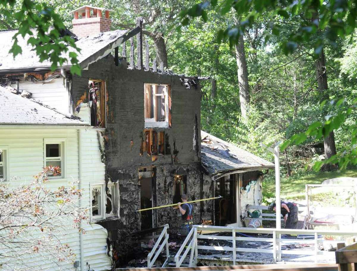 The aftermath of a house fire at 27 Deep Gorge Road in Western Greenwich Wednesday afternoon July 27, 2011. Pictured is the back area of the house where fire officials said the fire started.