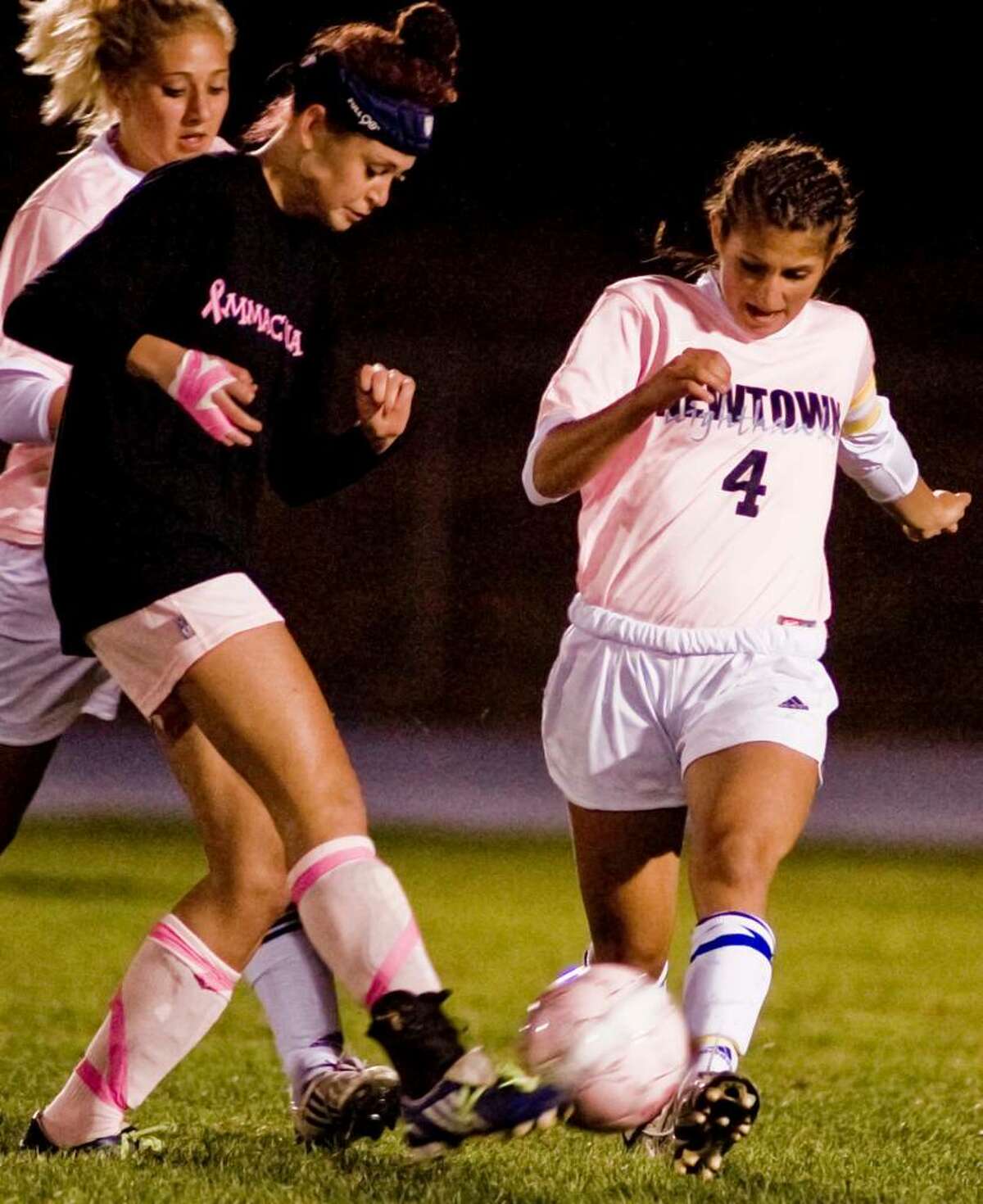 Immaculate sophomore Corina DaSilva and Newtown senior Ally Modzelewski battle for control in a girls soccer game at Newtown. Wednesday, Sept. 30, 2009