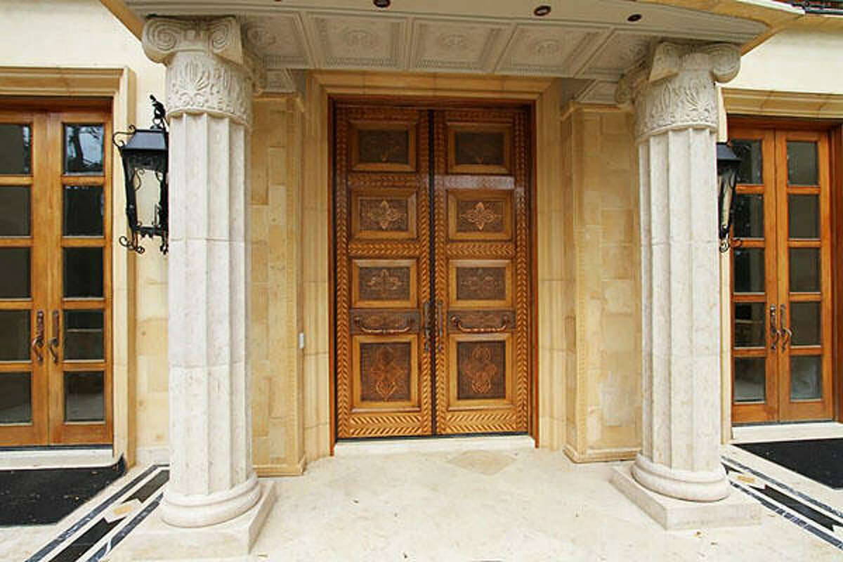 Front door of the home. The exterior of the property includes a detached four-car garage and a guest house.