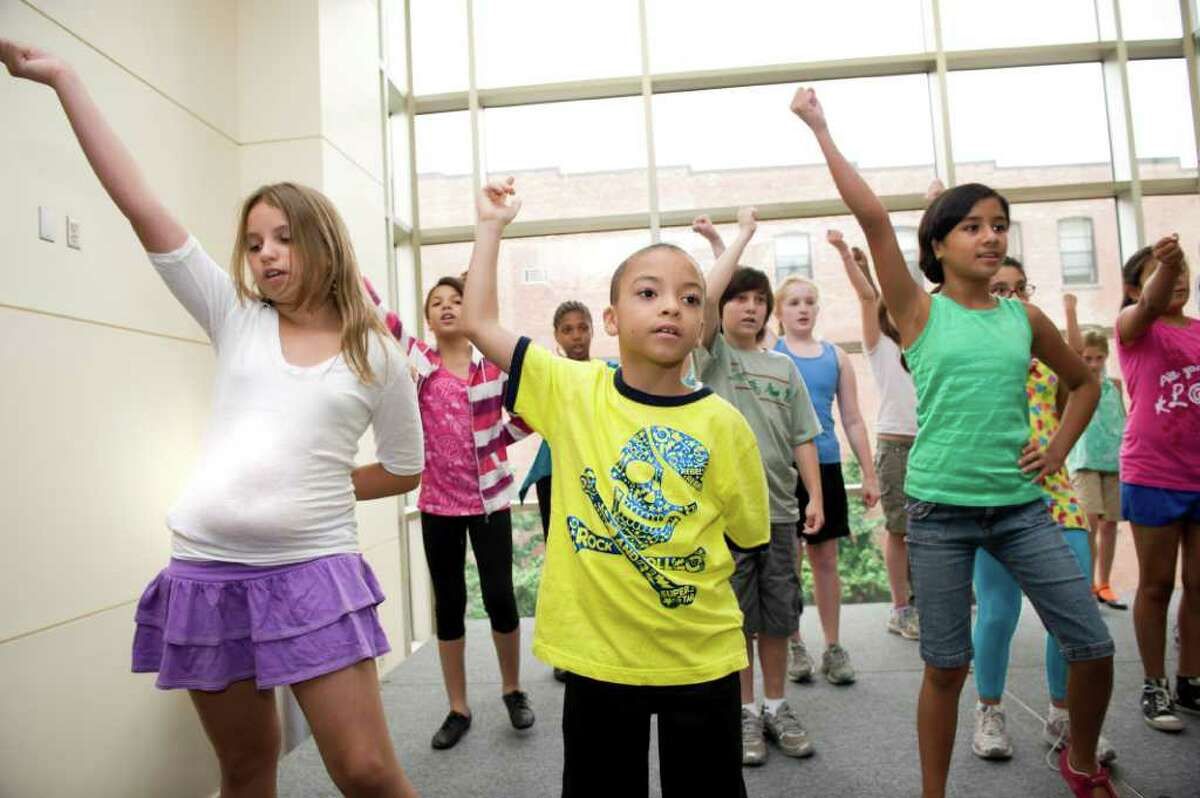 Sophia Schmitke (10), Nicholas Barlow (9) and Pamela Jaramillo (10 ) practice their dance moves at The Triple Threat Performer Intensive program at the Palace Theatre in Stamford, Conn. on Monday July 25, 2011.