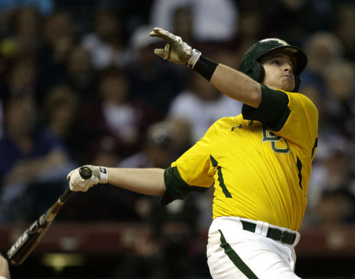 Baylor's Max Muncy watches the ball leave the park after hitting a grand slam home run.