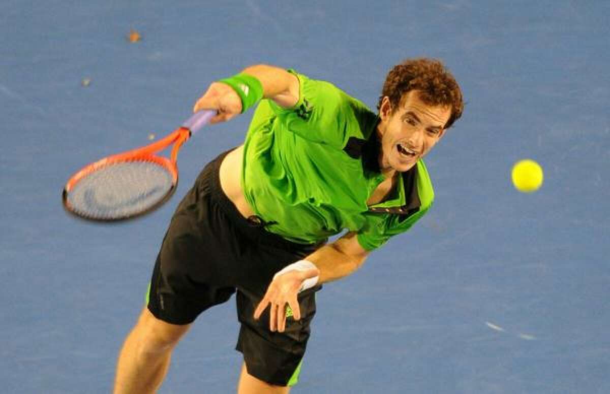 Andy Murray follows through on a serve to Novak Djokovic.