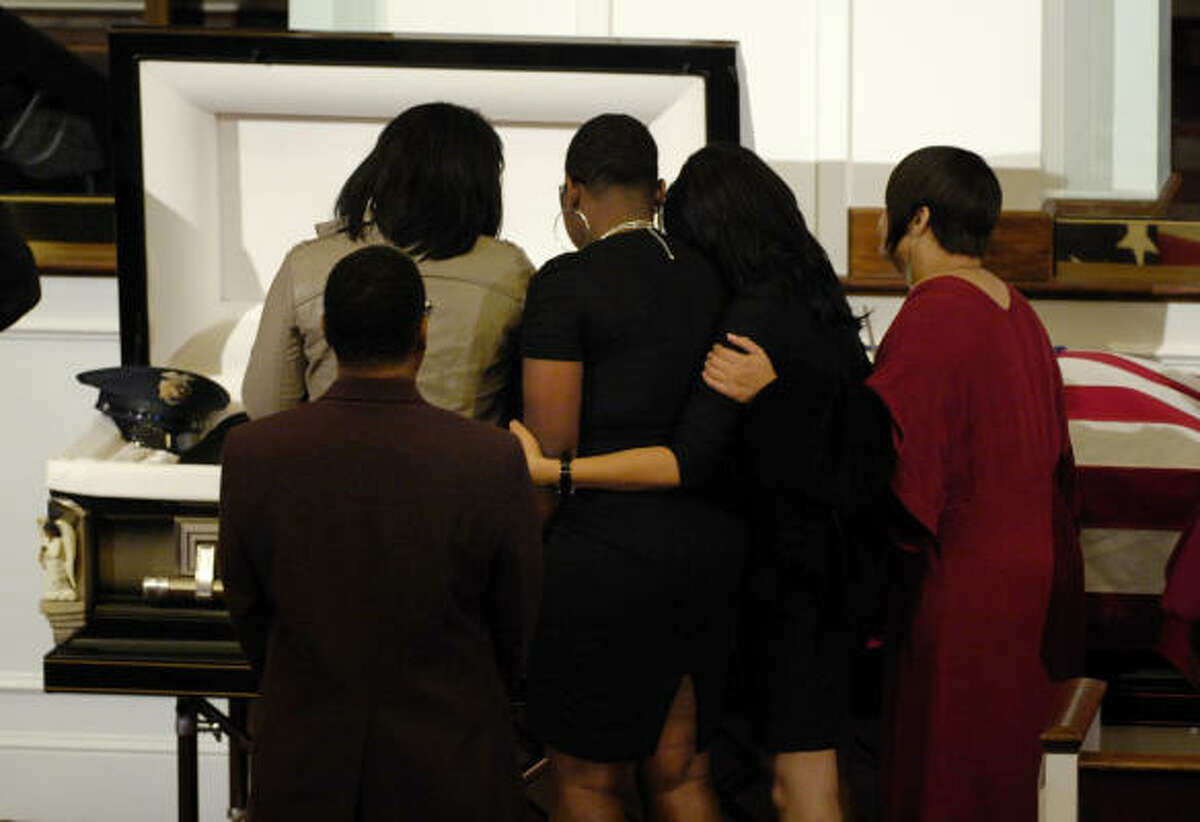 Mourners pass the open casket of Officer Jillian Smith during the memorial service at Mount Olive Baptist Church in Arlington, Texas.