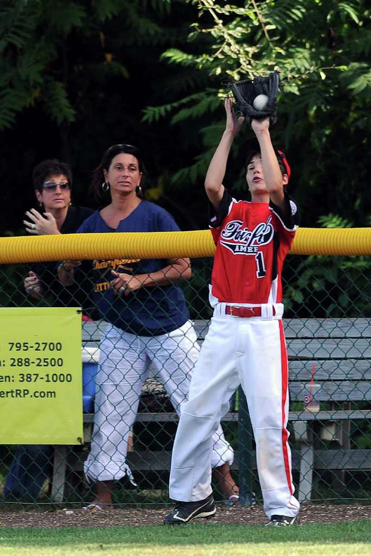 Sean Gutierrez makes a catch in the outfield during Wednesday's Fairfield American Little League Section 1 Championship game against East Haven in Orange on July 27, 3011.