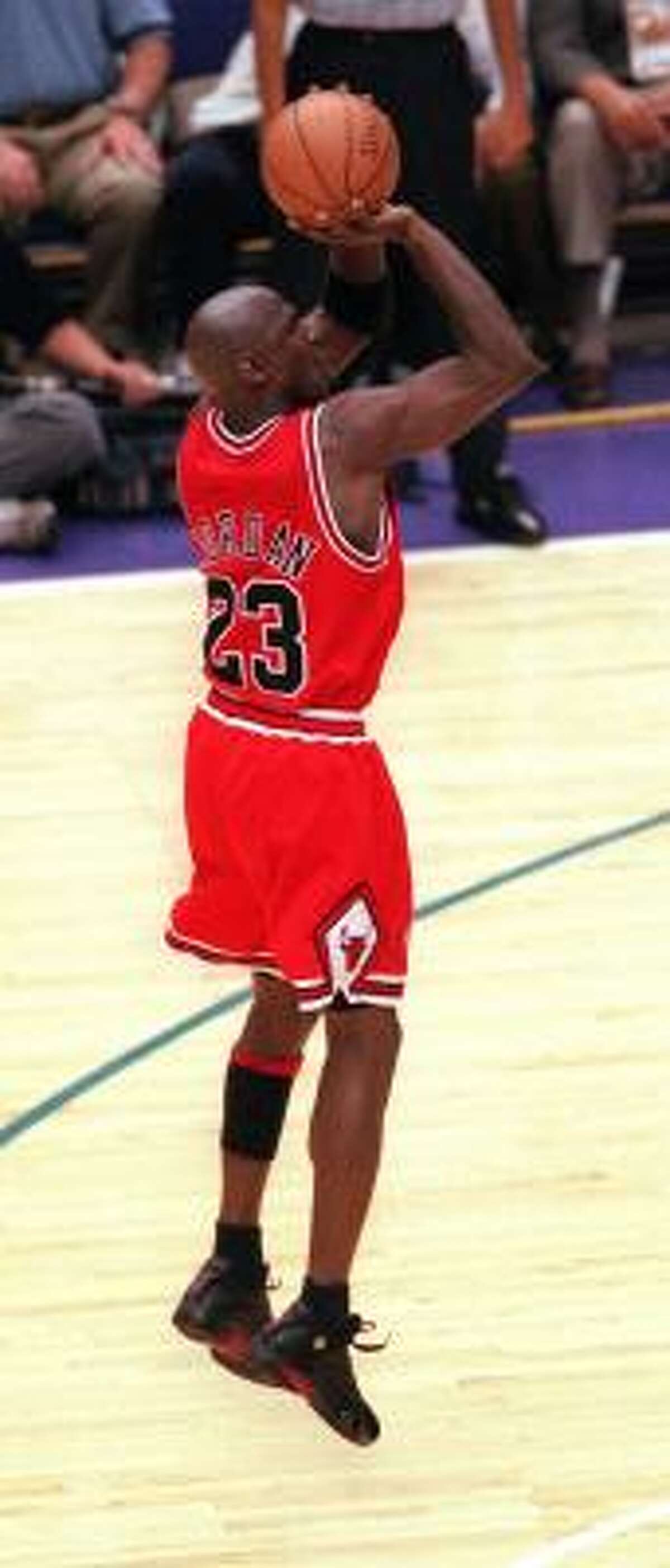 Michael Jordan, wearing the shoes that bear his name, fires in the winning shot in the 1998 NBA Finals.