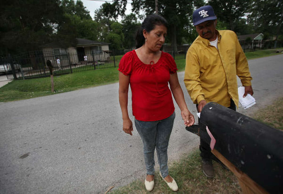 Eleuteria and Santiago Flores pick up mail at a property they own across the street from the house they purchased for $10,000, received a deed for and spent $30,000 fixing up only to find out they never owned the property and had been victims of a scam.