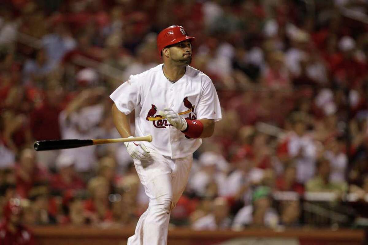 St. Louis Cardinals' Albert Pujols tosses his bat aside after flying out during the seventh inning of a baseball game against the Houston Astros Wednesday, July 27, 2011, in St. Louis.