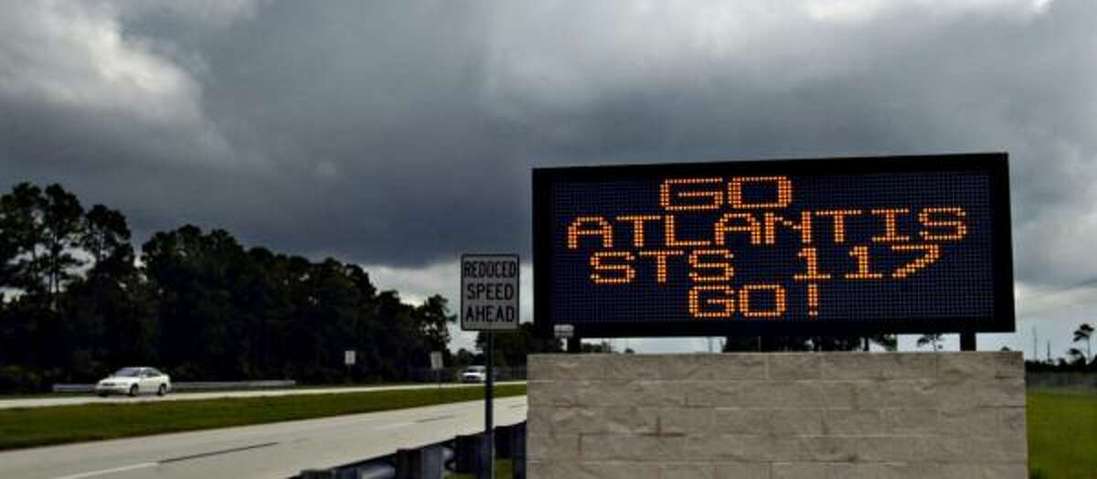 Dark clouds over Cape Canaveral, Fla., on Friday prompt NASA to land the shuttle in California.