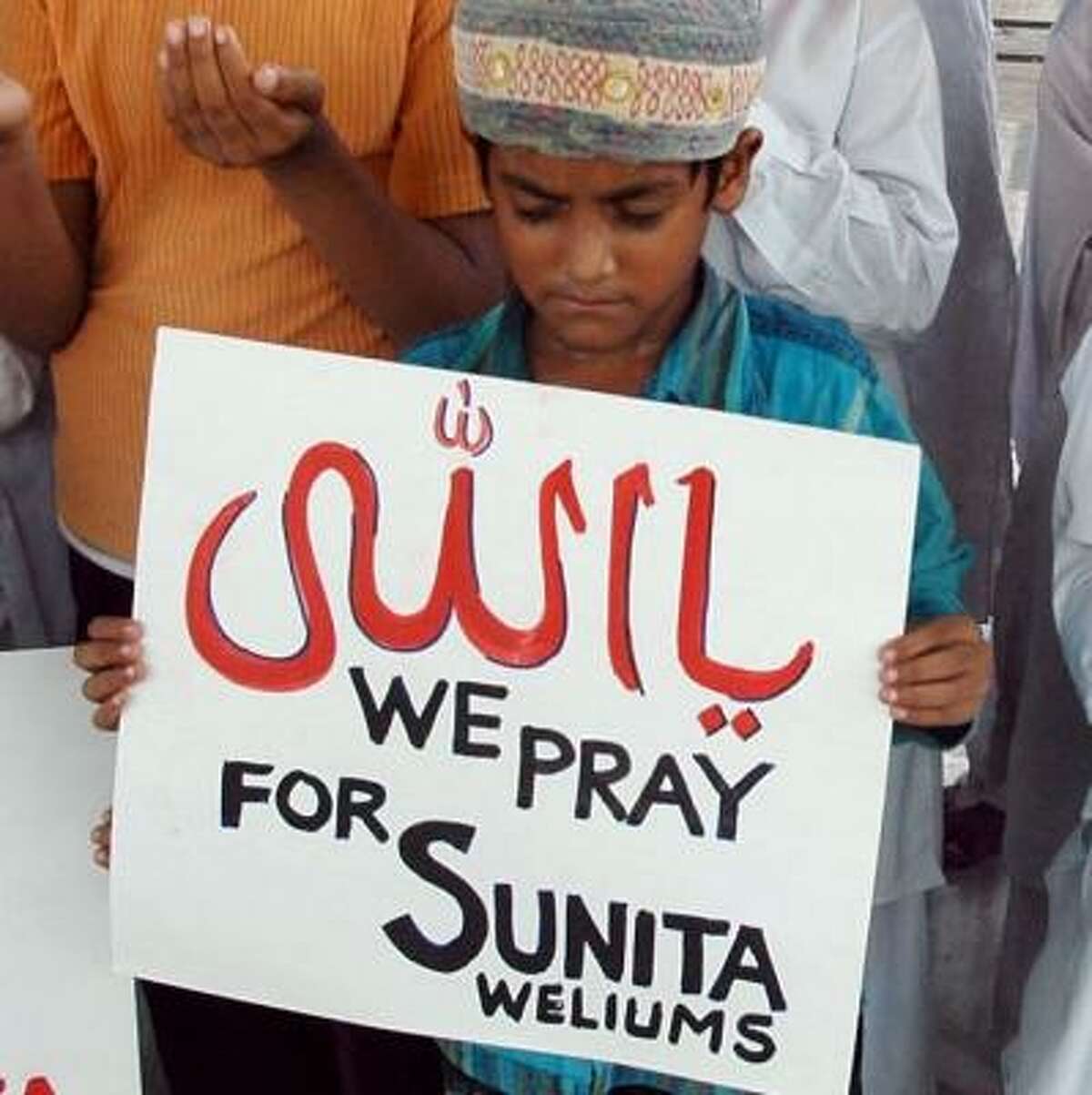 Muslim children in Ahmadabad, India, pray for the safe return Friday of Sunita Williams.