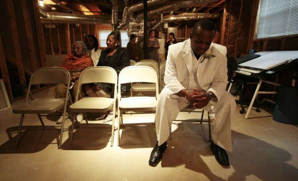Ronald Taylor sits in silence moments before his wedding is to begin. Taylor and Jeannette Brown exchanged vows Sunday in the basement of the home of the Rev. Marvin Adams, the bride's brother.