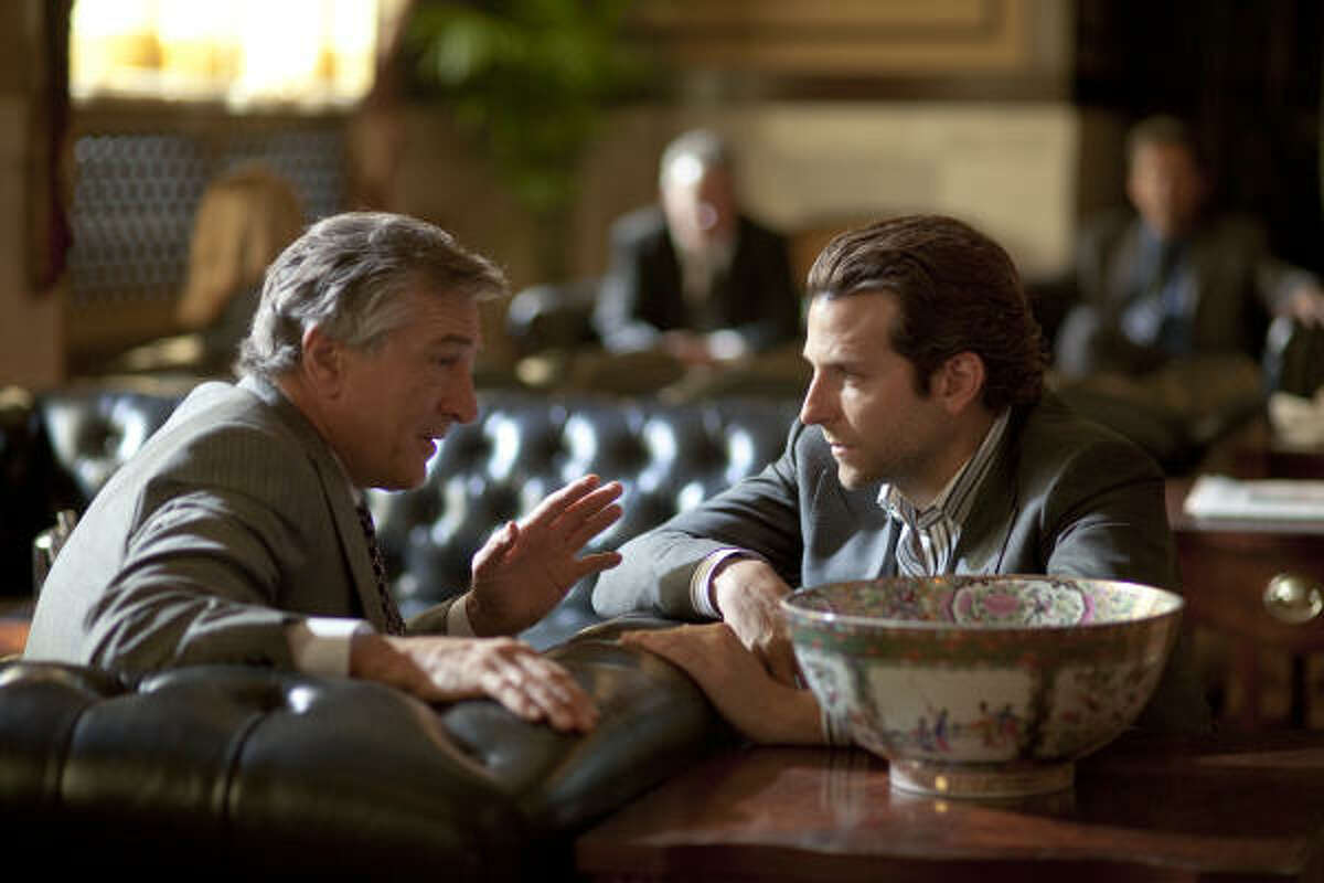 Carl (Robert De Niro, left) tells Eddie (Bradley Cooper) about the side effects of the wonder drug NZT.
