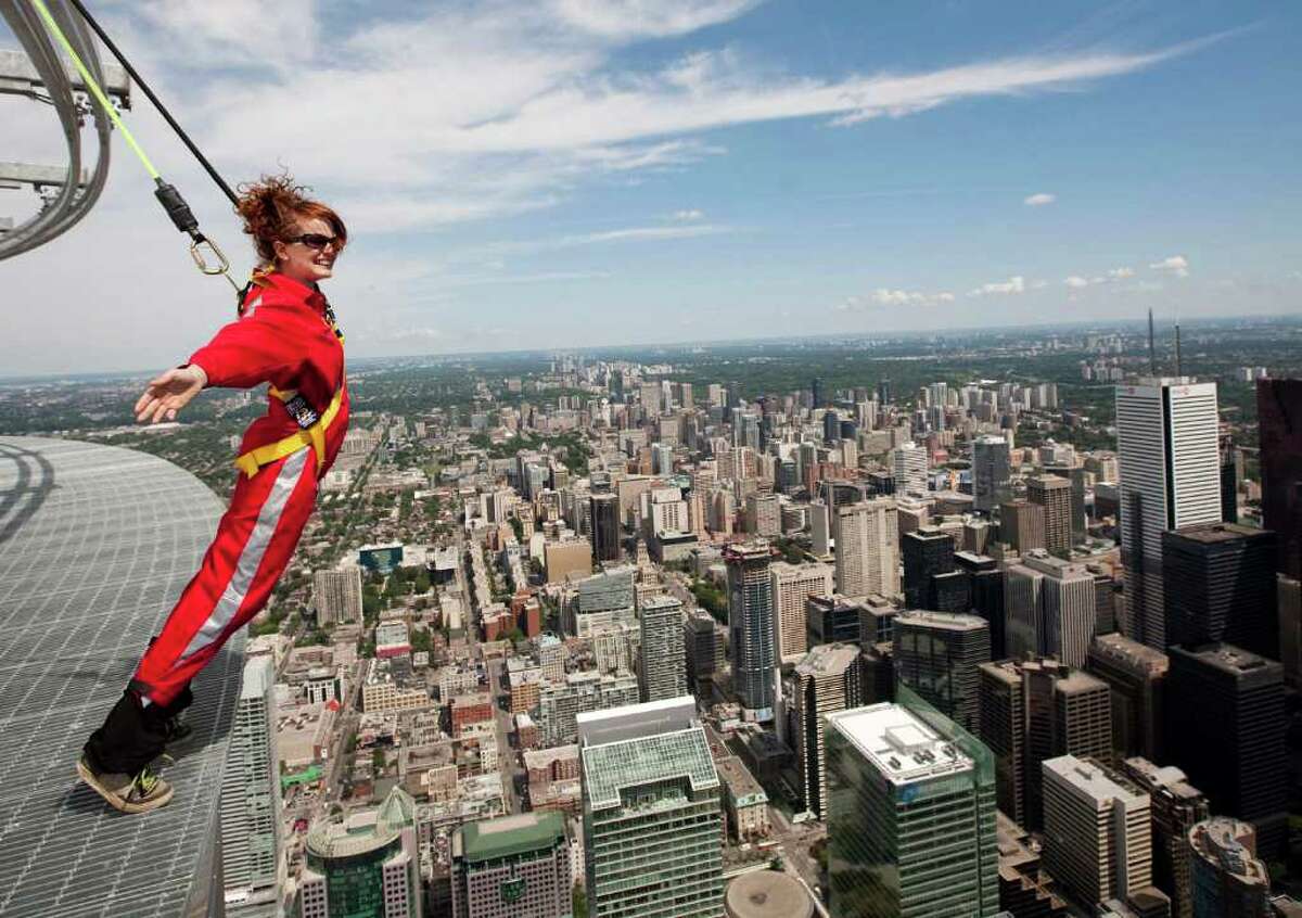 Toronto’s CN Tower just gave reporters a chance to try out its new EdgeWalk, which bills itself as “the world’s highest full circle hands-free walk.” Participants strap onto an overhead safety rail and then can walk on a 5-foot- wide ledge encircling the top of the  Tower’s main pod, 1,168 feet (116 stories) above the ground. Here's Canadian Press reporter Alex Posadzki trying it out on Wednesday, July 27, 2011.