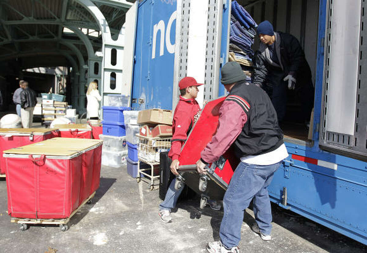 Astros batboy Patrick Eaves, left, and Chris Clarke, right, load baseball equipment into a moving truck with the help of Arturo Vargas on Thursday at Minute Maid Park. The team loaded its spring training equipment into a truck for a two-day trip to Kissimmee, Fla. The first spring training workout for Astros pitchers and catchers is Feb. 16 and and the first workout for position players is Feb. 20.